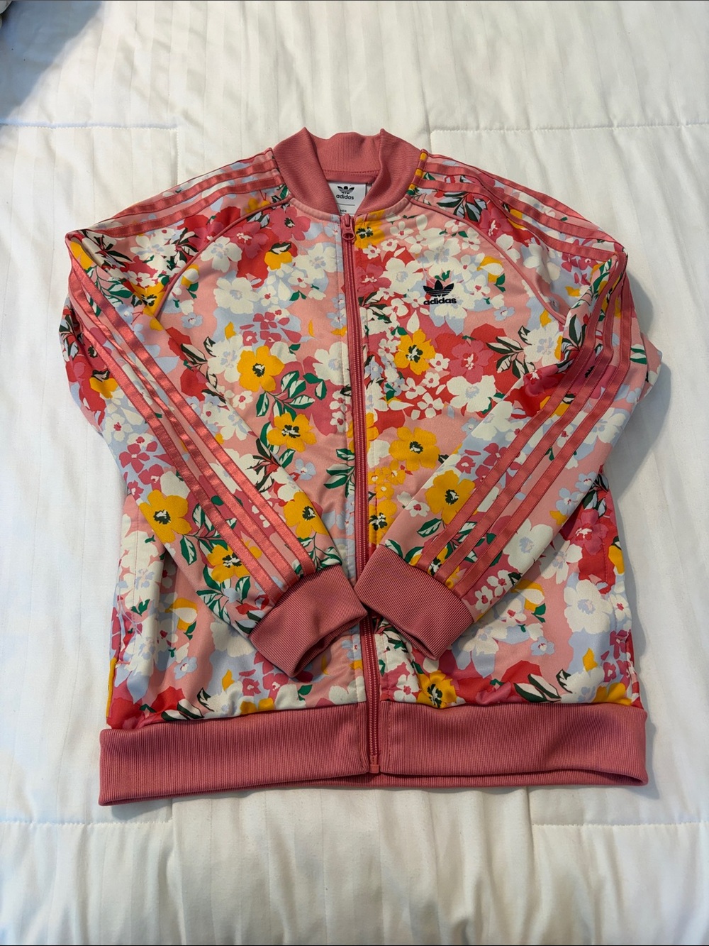 Adidas x HER Studio London zip-up track jacket with a colorful floral pattern